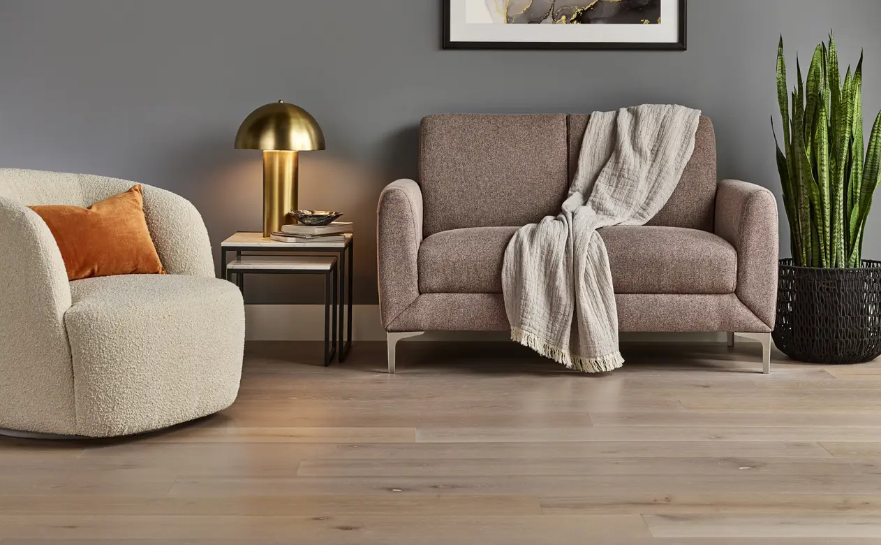 Natural hardwood living room with beige furniture and orange pillow 